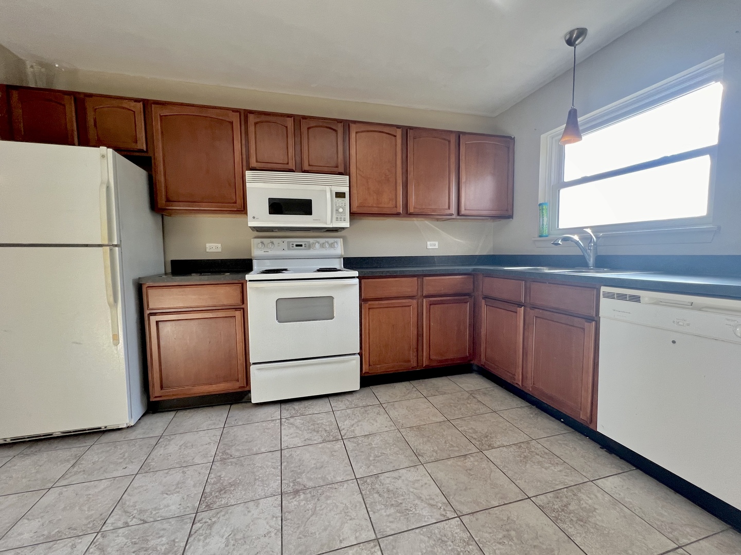 2225 West Nichols Road, Unit D Arlington Heights, IL 60004 - Photo 2 of 12 a kitchen with a stove sink and refrigerator