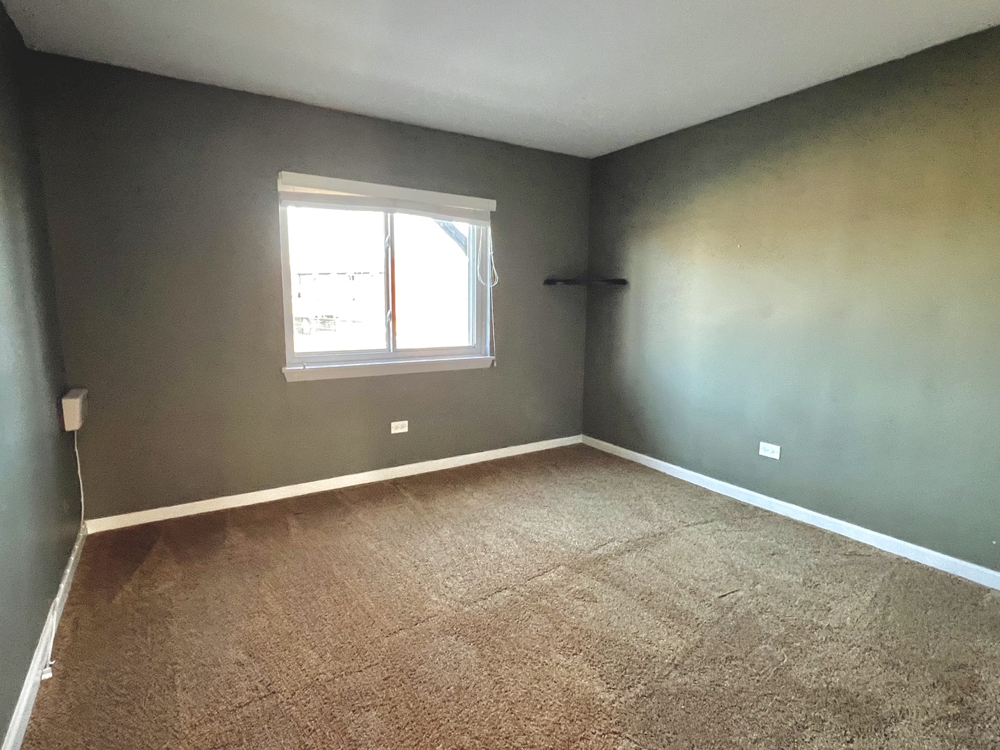 2225 West Nichols Road, Unit D Arlington Heights, IL 60004 - Photo 9 of 12 an empty room with a window