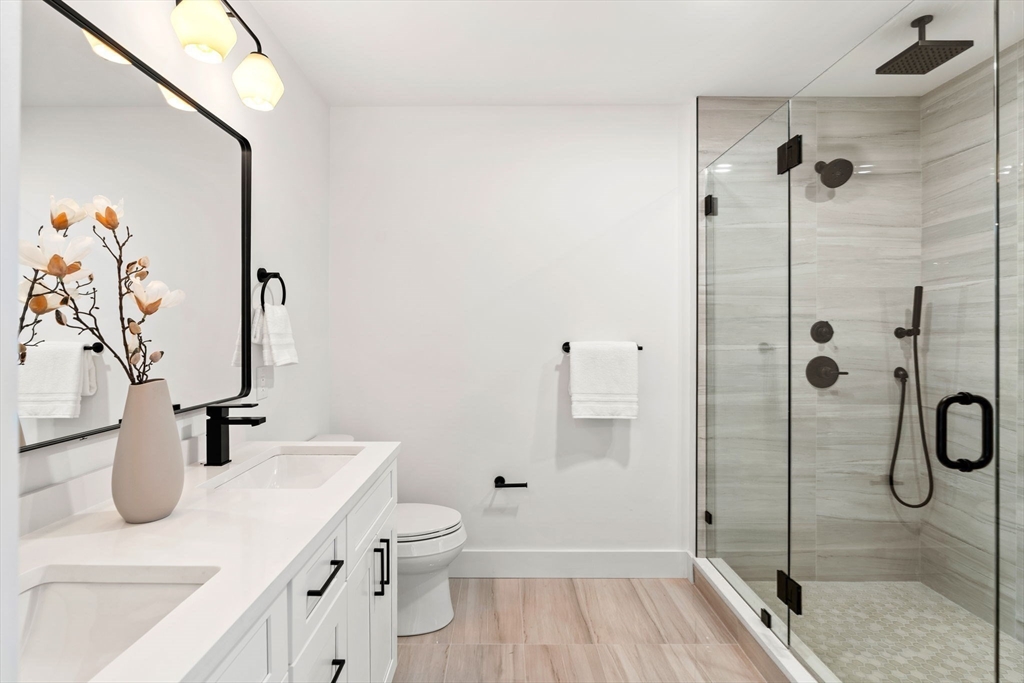 4 Wilbur Street Woburn, MA 01801 - Photo 17 of 39 a bathroom with a sink a toilet and shower
