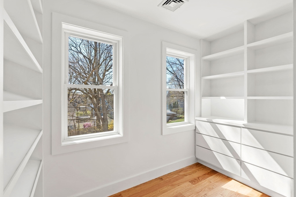 4 Wilbur Street Woburn, MA 01801 - Photo 18 of 39 a view of an empty room with a window and wooden floor