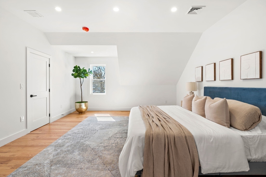 4 Wilbur Street Woburn, MA 01801 - Photo 21 of 39 a bedroom with a bed and a potted plant
