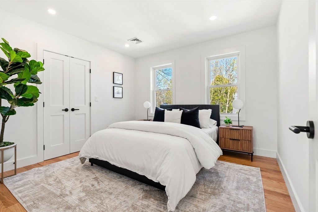 4 Wilbur Street Woburn, MA 01801 - Photo 25 of 39 a bedroom with a bed and a potted plant