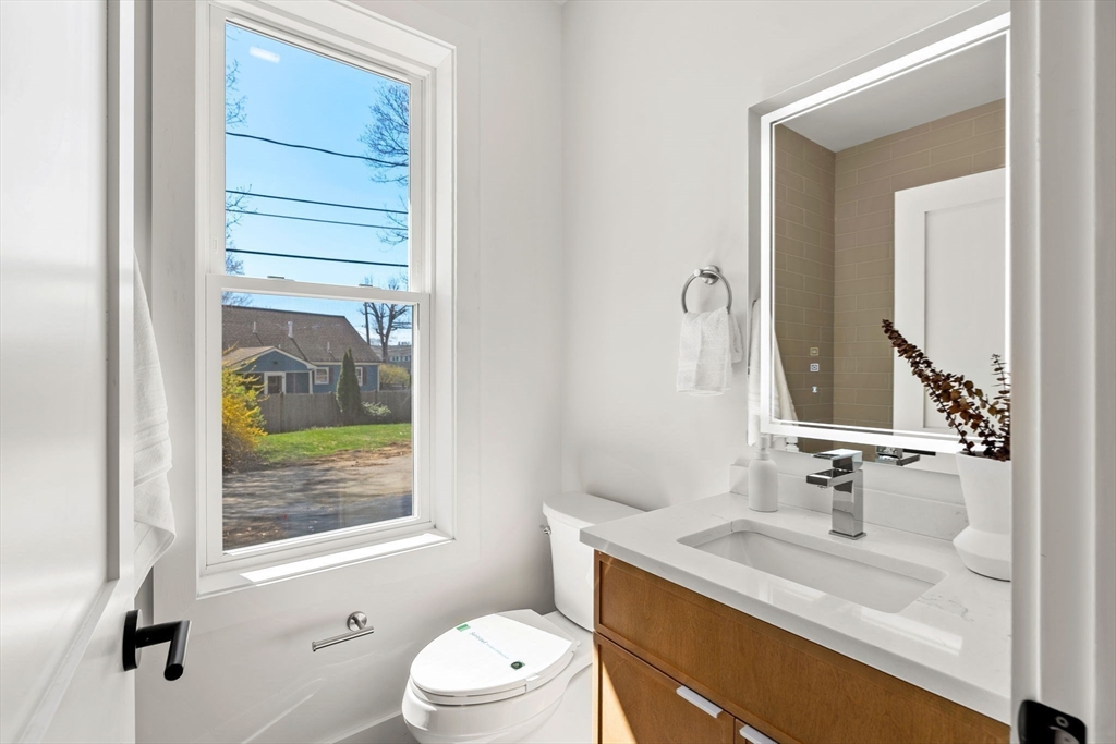 4 Wilbur Street Woburn, MA 01801 - Photo 31 of 39 a bathroom with a granite countertop sink toilet and mirror