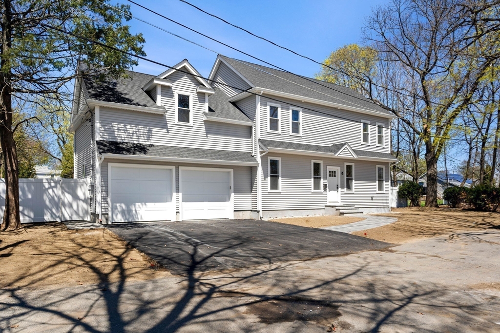 4 Wilbur Street Woburn, MA 01801 - Photo 34 of 39 a front view of a building with a garden