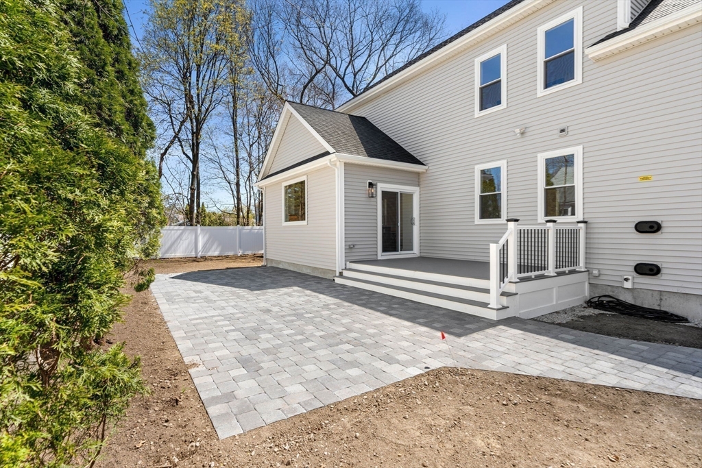 4 Wilbur Street Woburn, MA 01801 - Photo 36 of 39 a front view of a house with a yard and garage