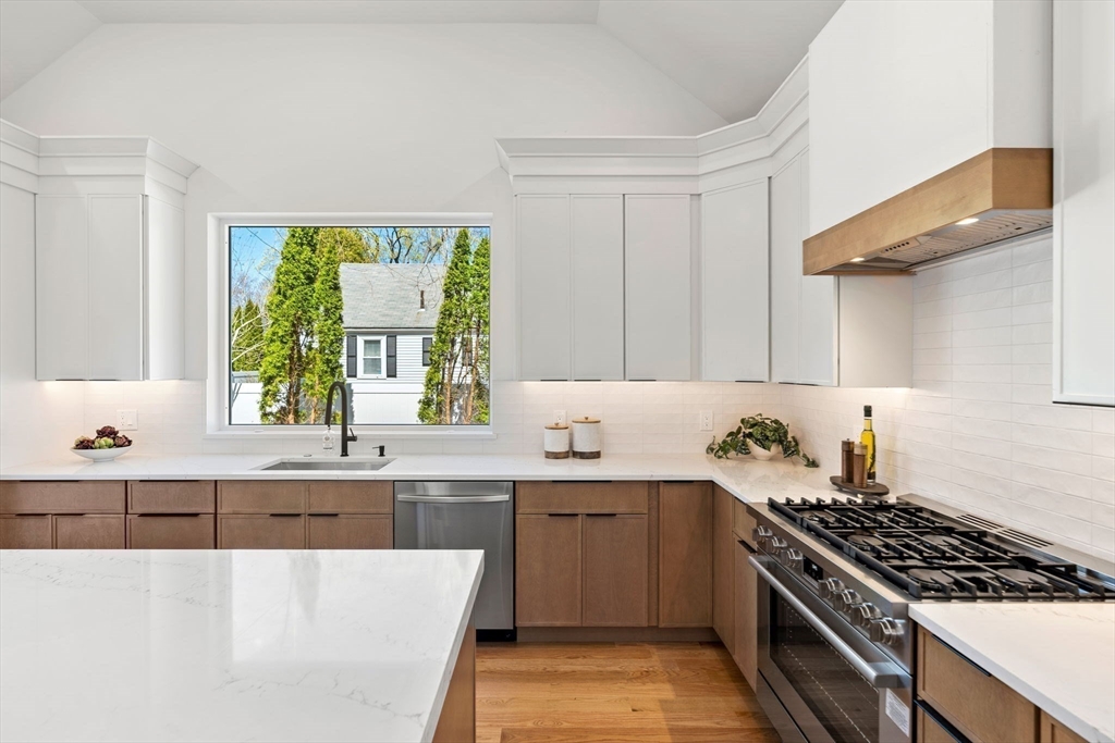 4 Wilbur Street Woburn, MA 01801 - Photo 5 of 39 a kitchen with a sink stove and cabinets