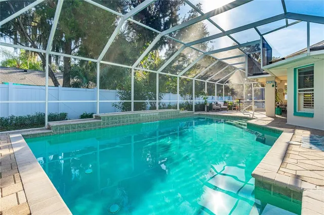 a view of a backyard with table and chairs and wooden fence
