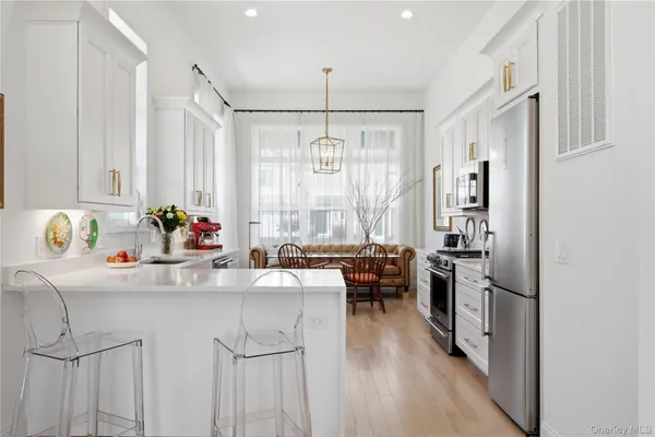 a kitchen with granite countertop a sink stove and refrigerator