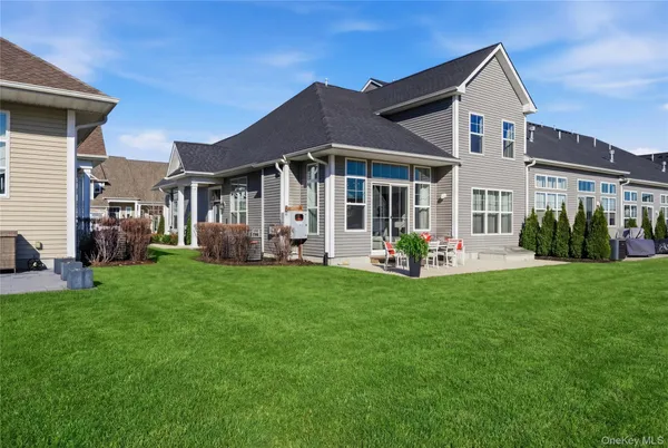 a view of a house with a yard and a porch