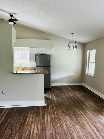 a kitchen with kitchen island a sink appliances and cabinets