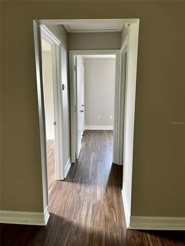 a view of a hallway with wooden floor