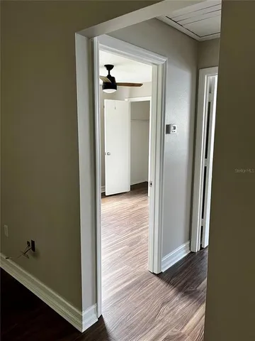 an empty room with wooden floor and closet