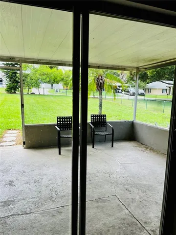 a view of a swimming pool with a couple of chairs