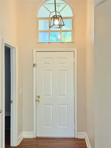 a view of a hallway with wooden door