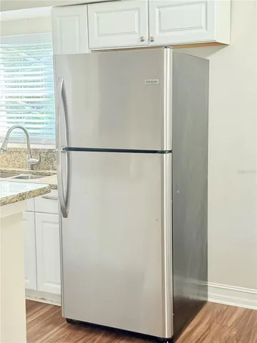 a white refrigerator freezer sitting in a kitchen