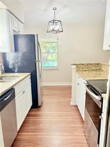a kitchen with a sink stove and refrigerator