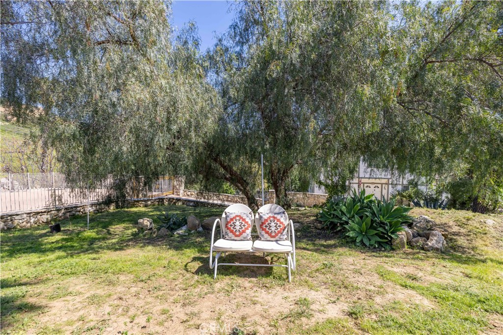 120 Rollins Road Chatsworth, CA 91311 - Photo 20 of 25 a backyard of a house with table and chairs