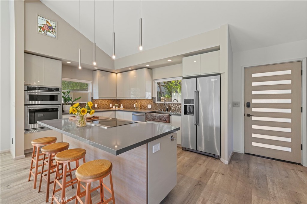 120 Rollins Road Chatsworth, CA 91311 - Photo 4 of 25 a kitchen with stainless steel appliances granite countertop a sink a stove and a refrigerator