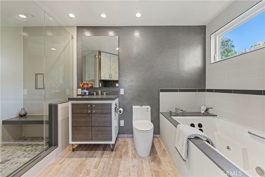 120 Rollins Road Chatsworth, CA 91311 - Photo 10 of 25 a bathroom with a double vanity sink a mirror and a bathtub