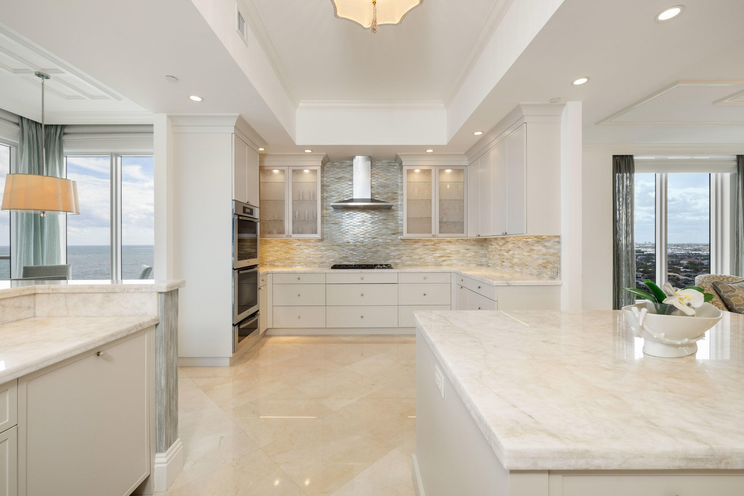 5050 North Ocean Drive, Unit 1502 Singer Island, FL 33404 - Photo 12 of 56 a large white kitchen with a large window