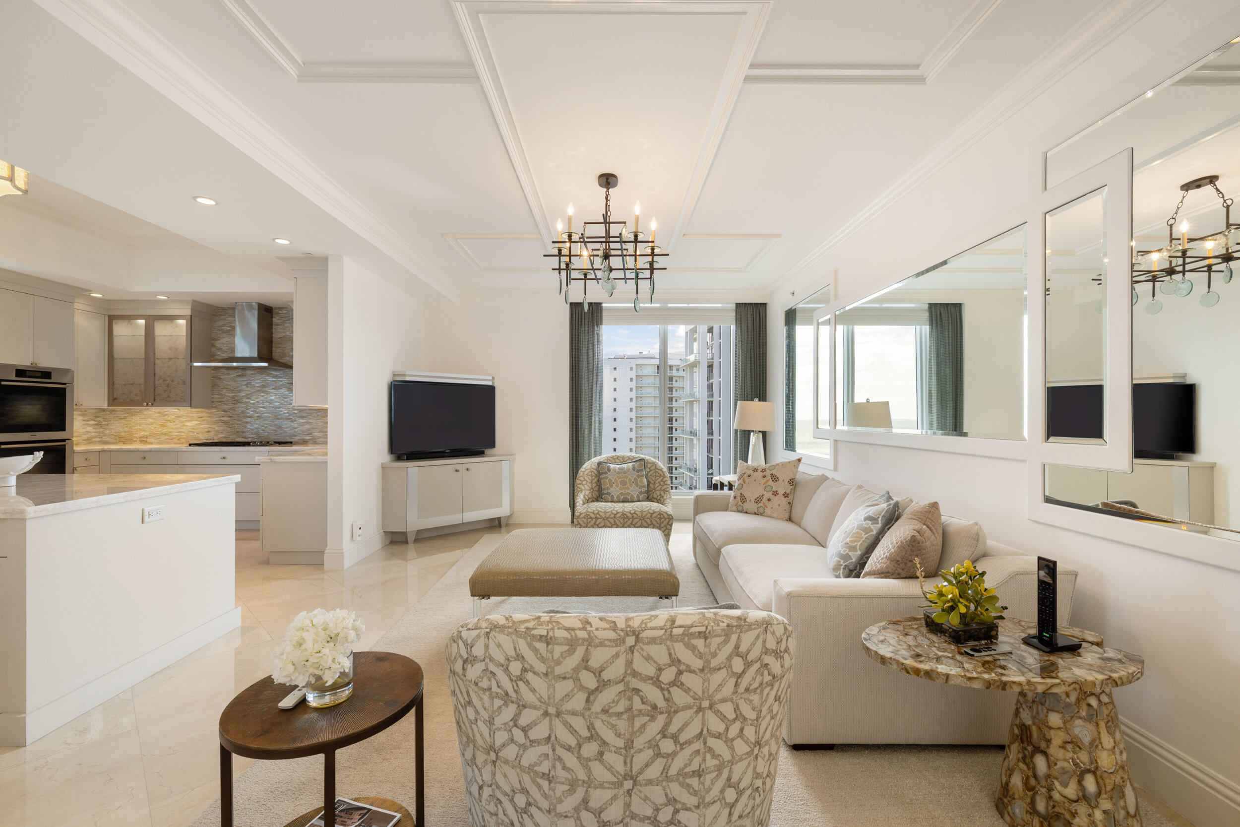 5050 North Ocean Drive, Unit 1502 Singer Island, FL 33404 - Photo 17 of 56 a living room with furniture a flat screen tv and a large window