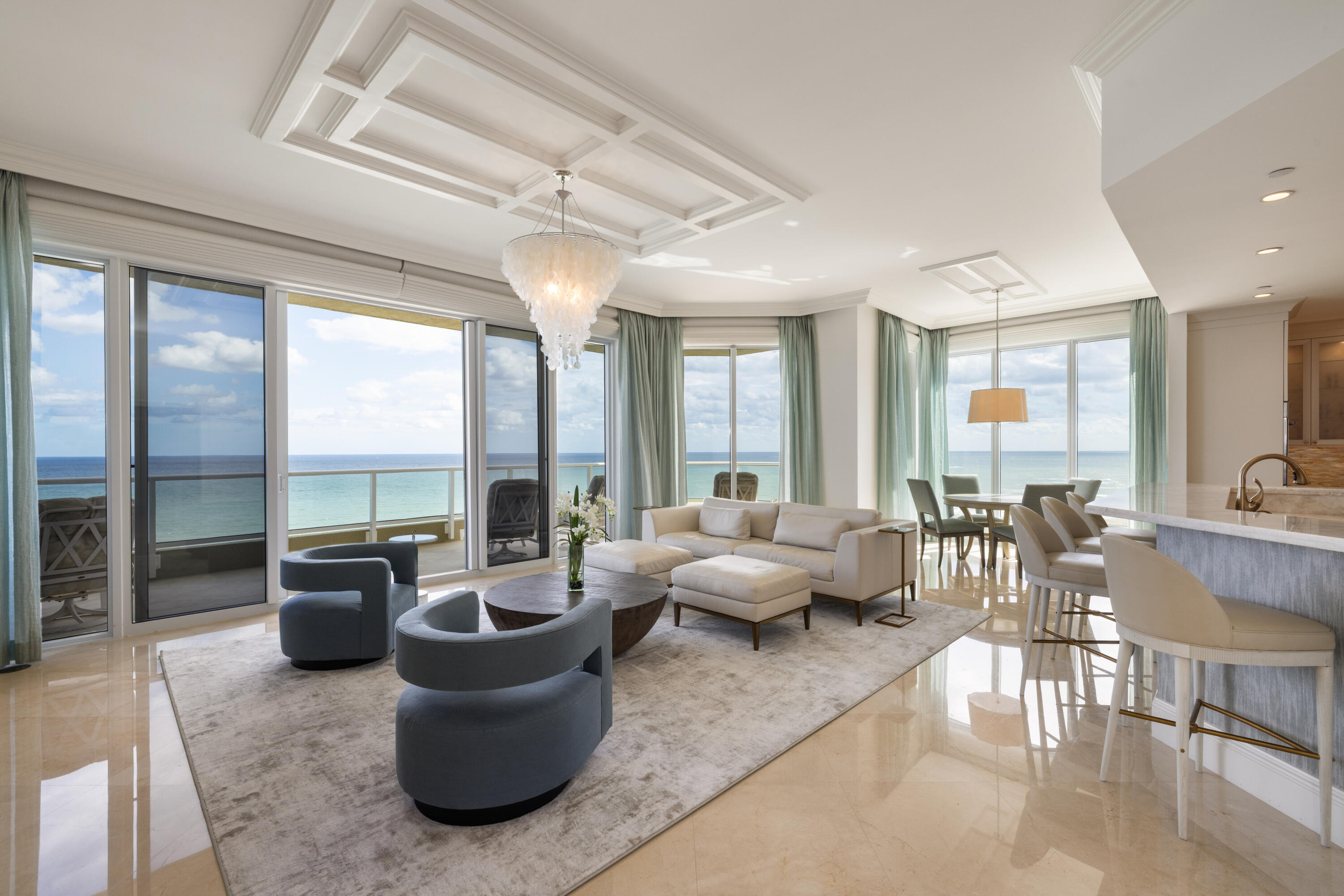 5050 North Ocean Drive, Unit 1502 Singer Island, FL 33404 - Photo 2 of 56 a living room with furniture and floor to ceiling windows