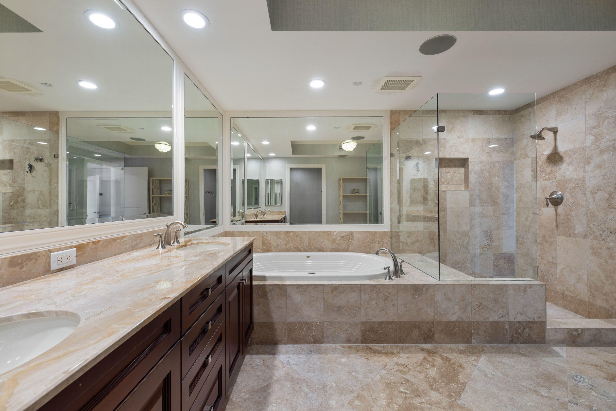 5050 North Ocean Drive, Unit 1502 Singer Island, FL 33404 - Photo 22 of 56 a bathroom with a granite countertop tub a sink and a large mirror