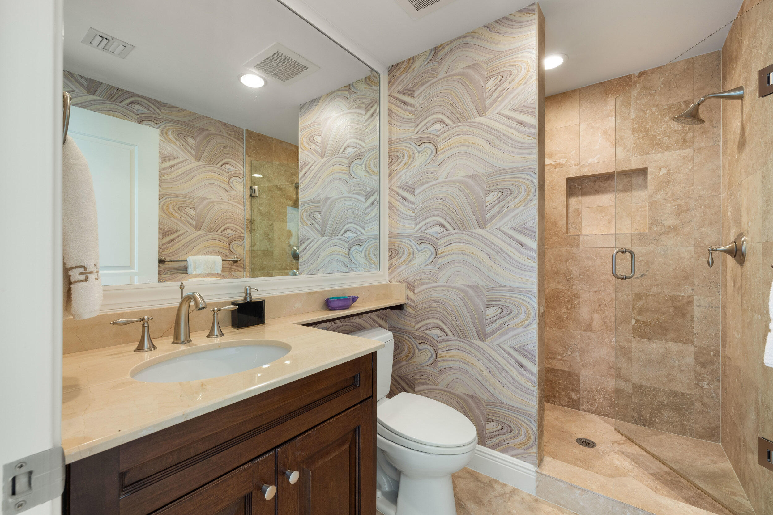 5050 North Ocean Drive, Unit 1502 Singer Island, FL 33404 - Photo 29 of 56 a bathroom with a sink toilet a mirror and shower