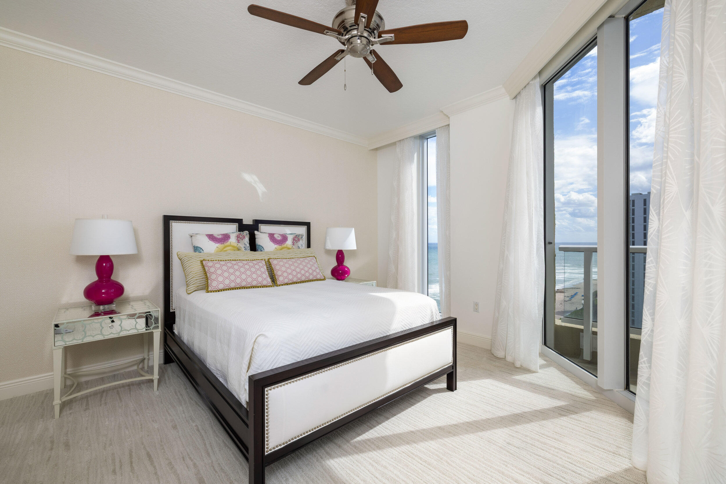 5050 North Ocean Drive, Unit 1502 Singer Island, FL 33404 - Photo 31 of 56 a bedroom with a bed and a chandelier