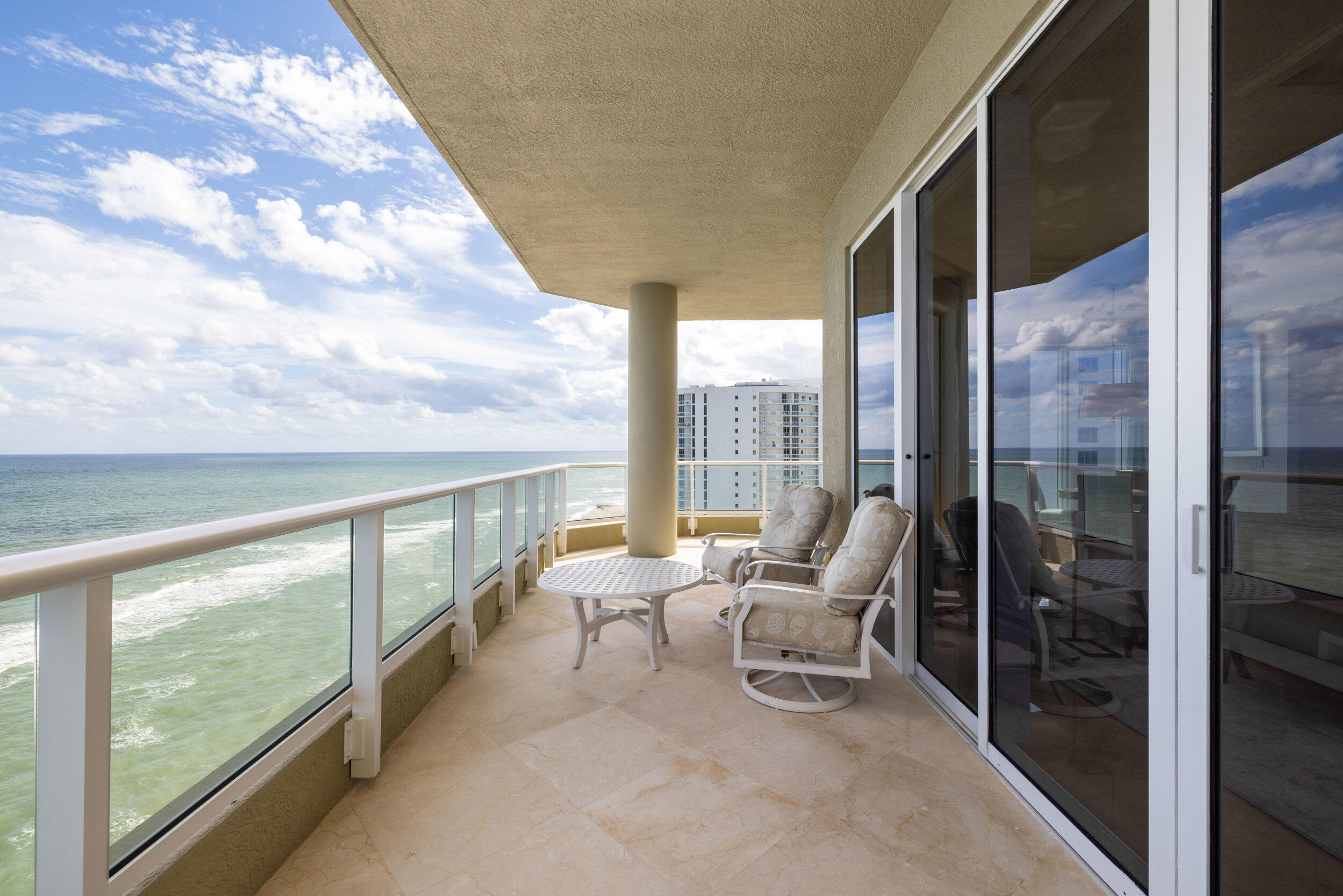 5050 North Ocean Drive, Unit 1502 Singer Island, FL 33404 - Photo 36 of 56 a living room with furniture and a floor to ceiling window