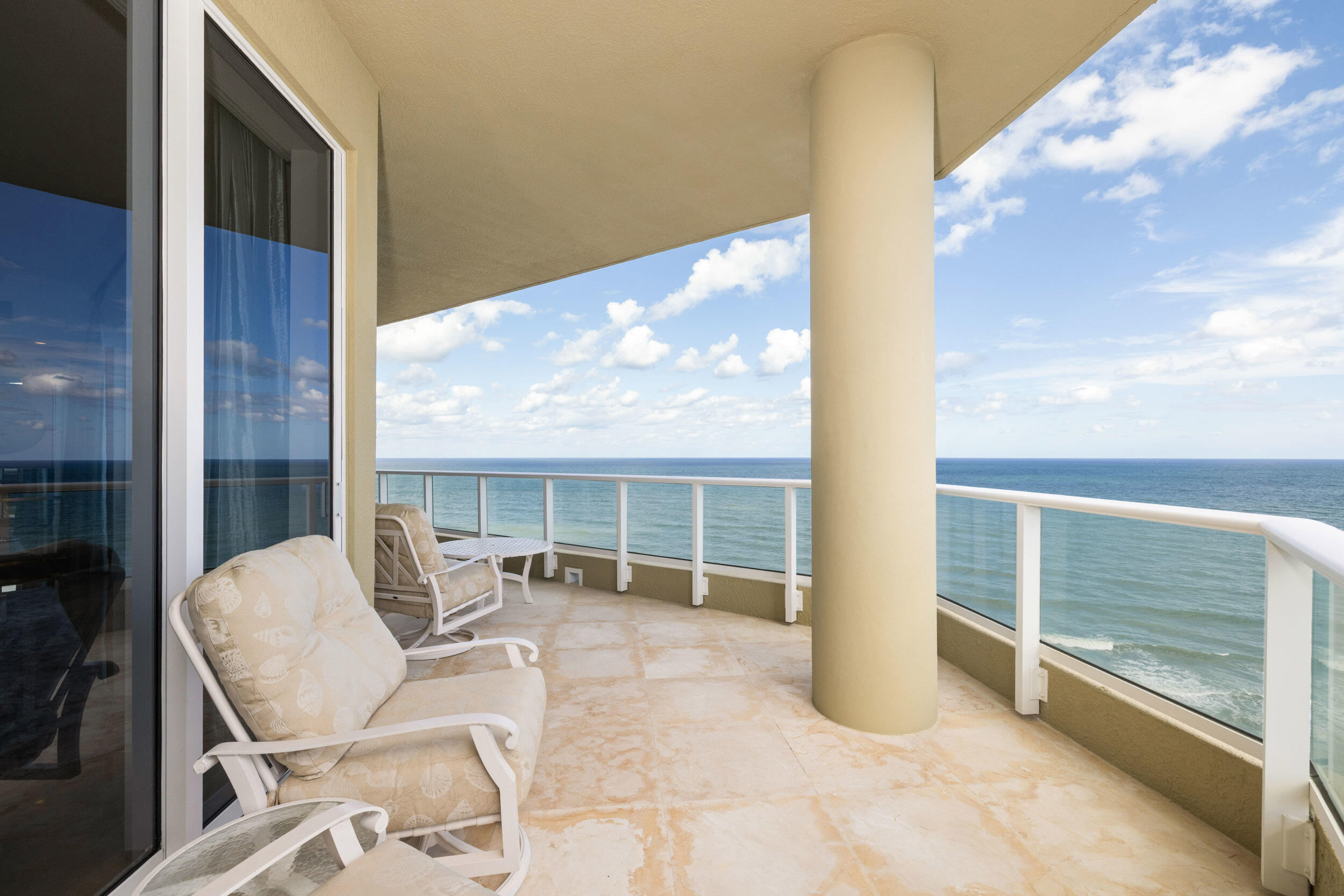 5050 North Ocean Drive, Unit 1502 Singer Island, FL 33404 - Photo 38 of 56 a balcony with table and chairs
