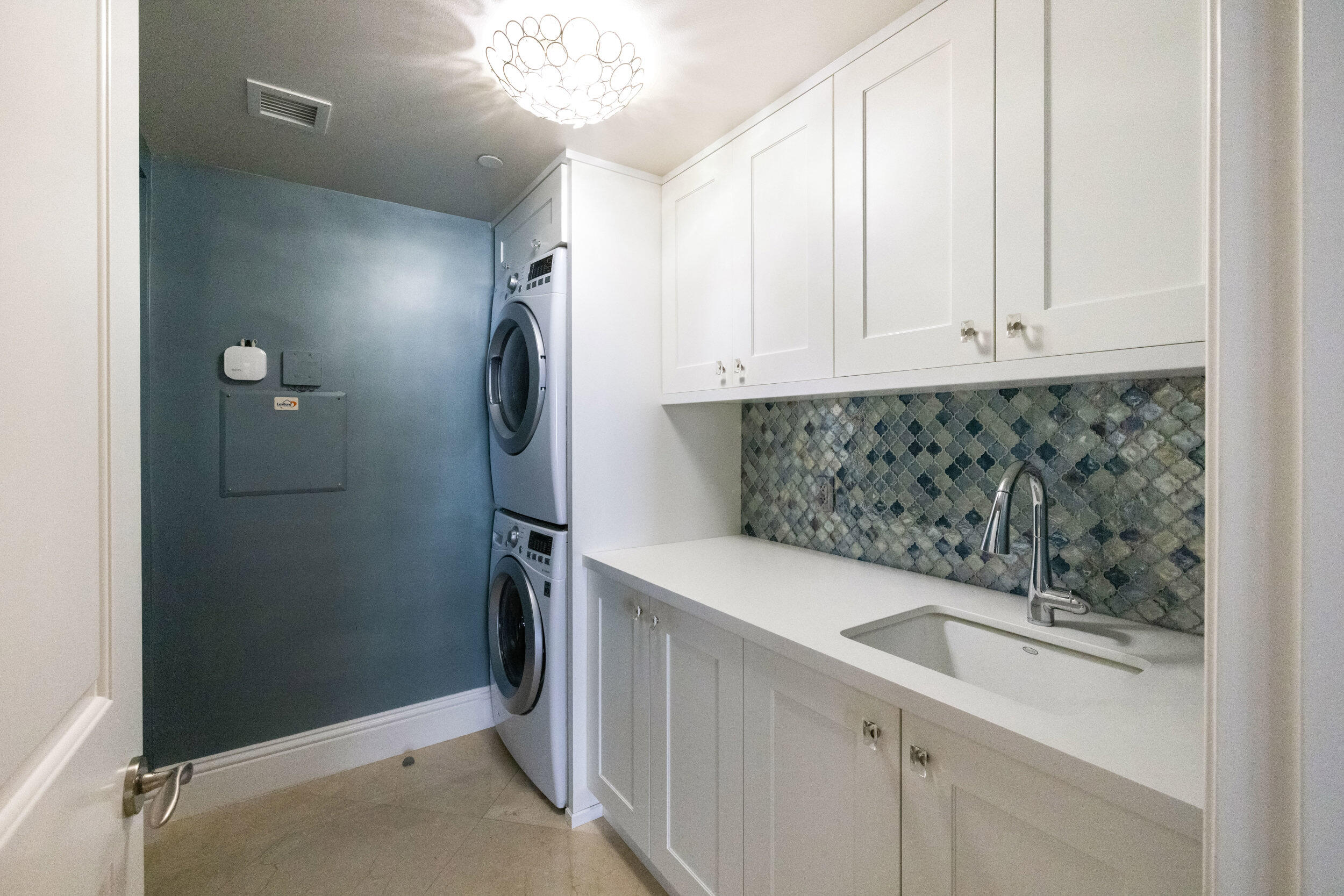 5050 North Ocean Drive, Unit 1502 Singer Island, FL 33404 - Photo 40 of 56 a kitchen with a sink and cabinets