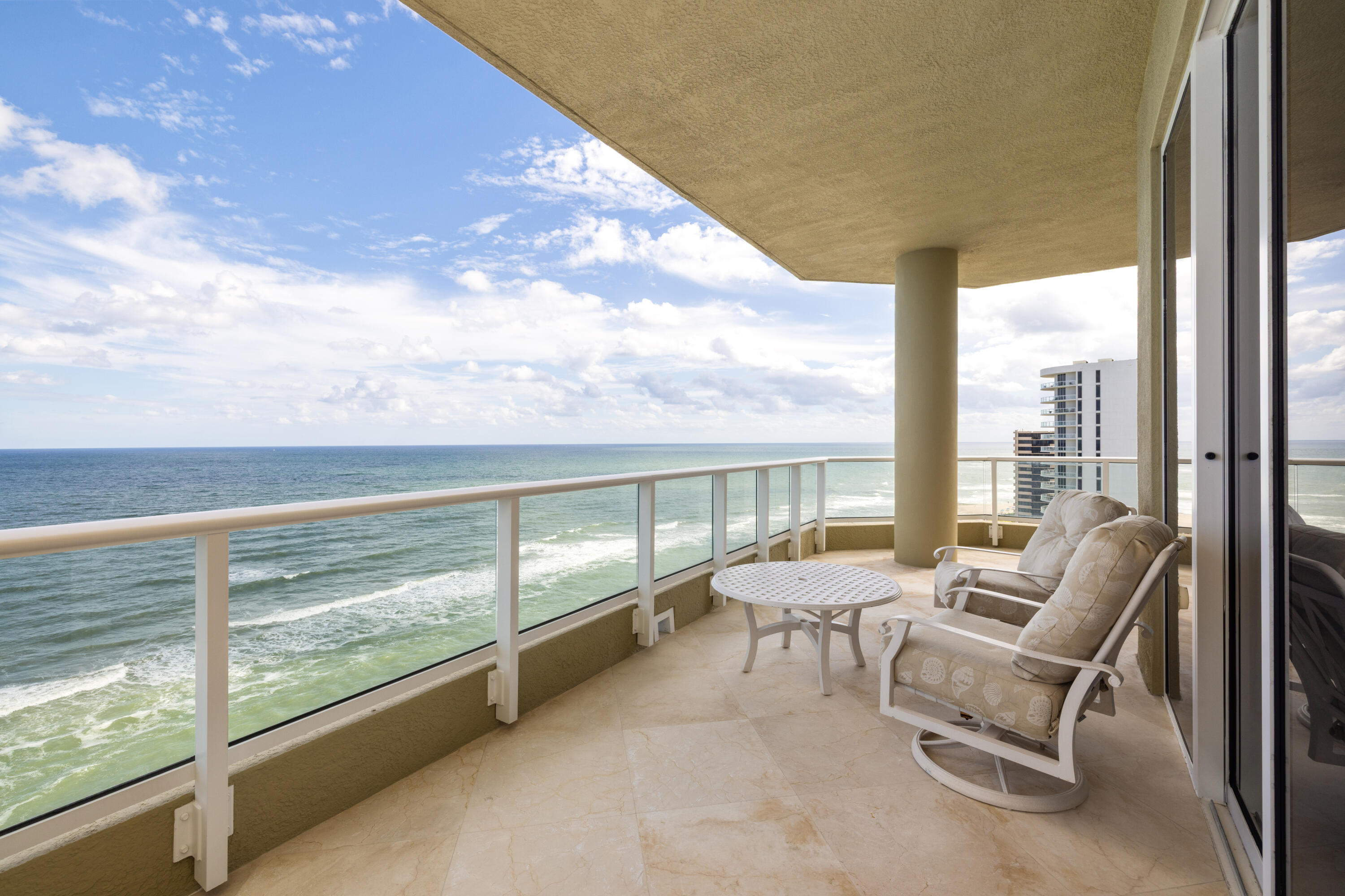 5050 North Ocean Drive, Unit 1502 Singer Island, FL 33404 - Photo 4 of 56 a living room with furniture and floor to ceiling windows