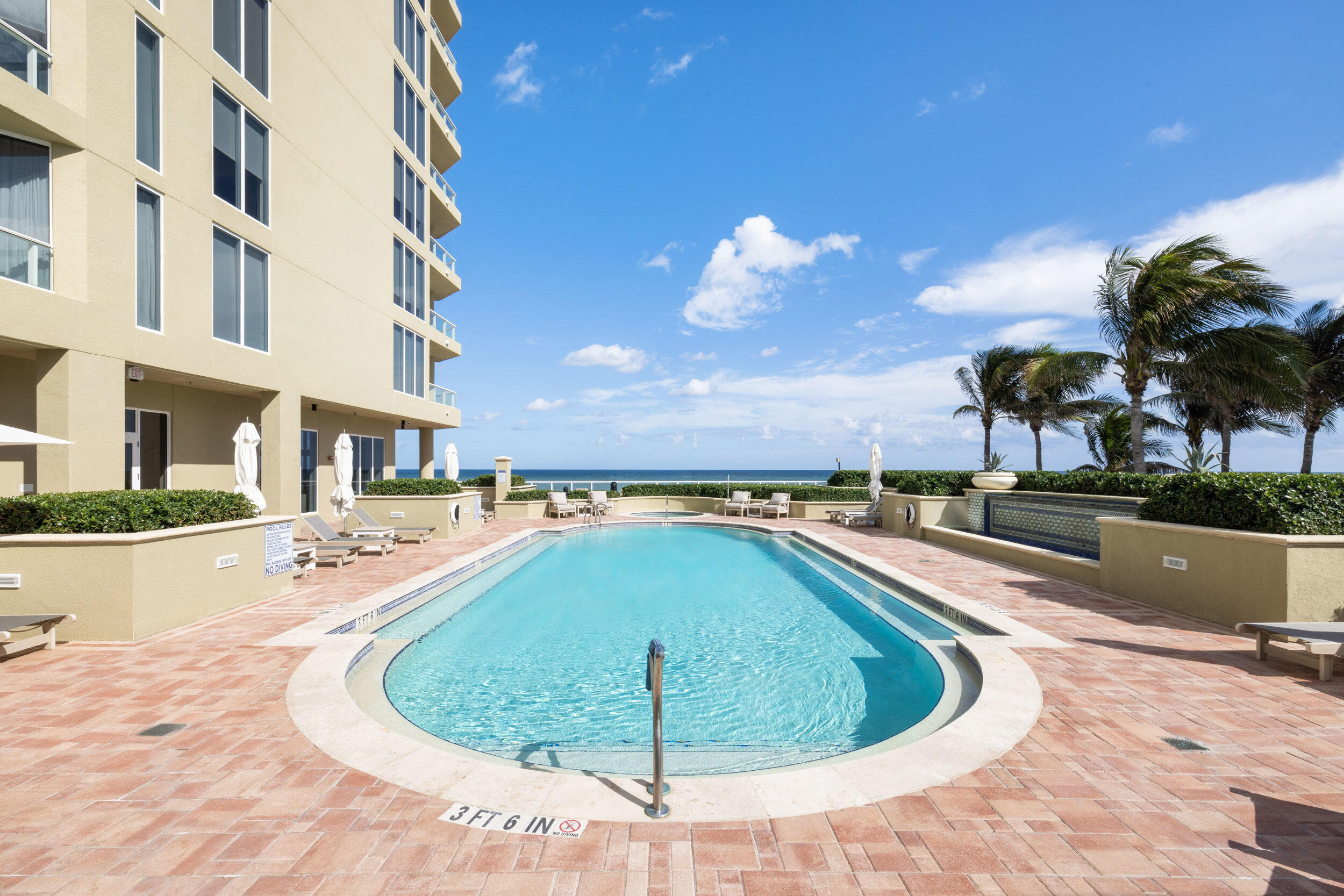 5050 North Ocean Drive, Unit 1502 Singer Island, FL 33404 - Photo 41 of 56 a view of a swimming pool with a lounge chairs