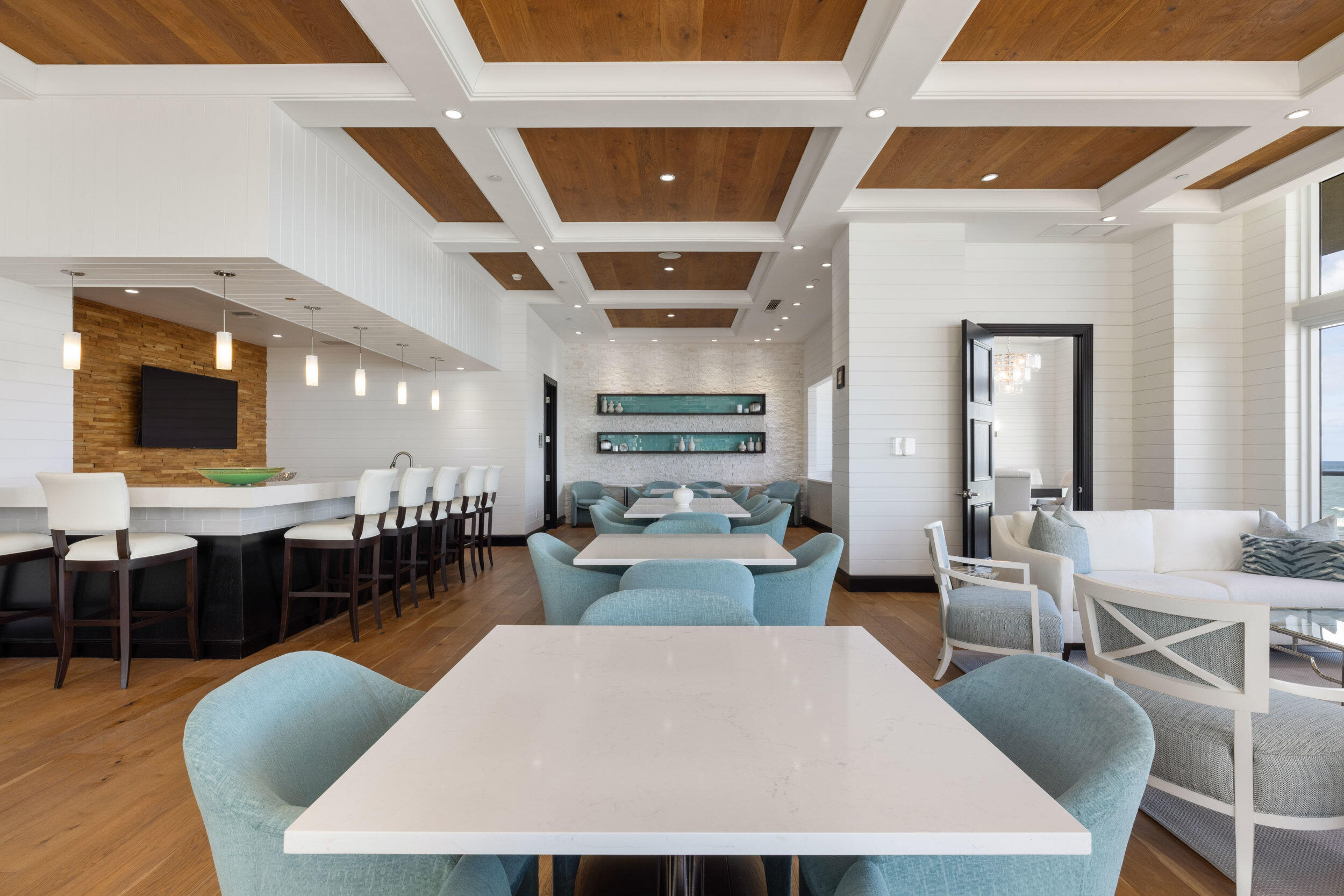 5050 North Ocean Drive, Unit 1502 Singer Island, FL 33404 - Photo 46 of 56 a large room with lots of white furniture a rug and a chandelier