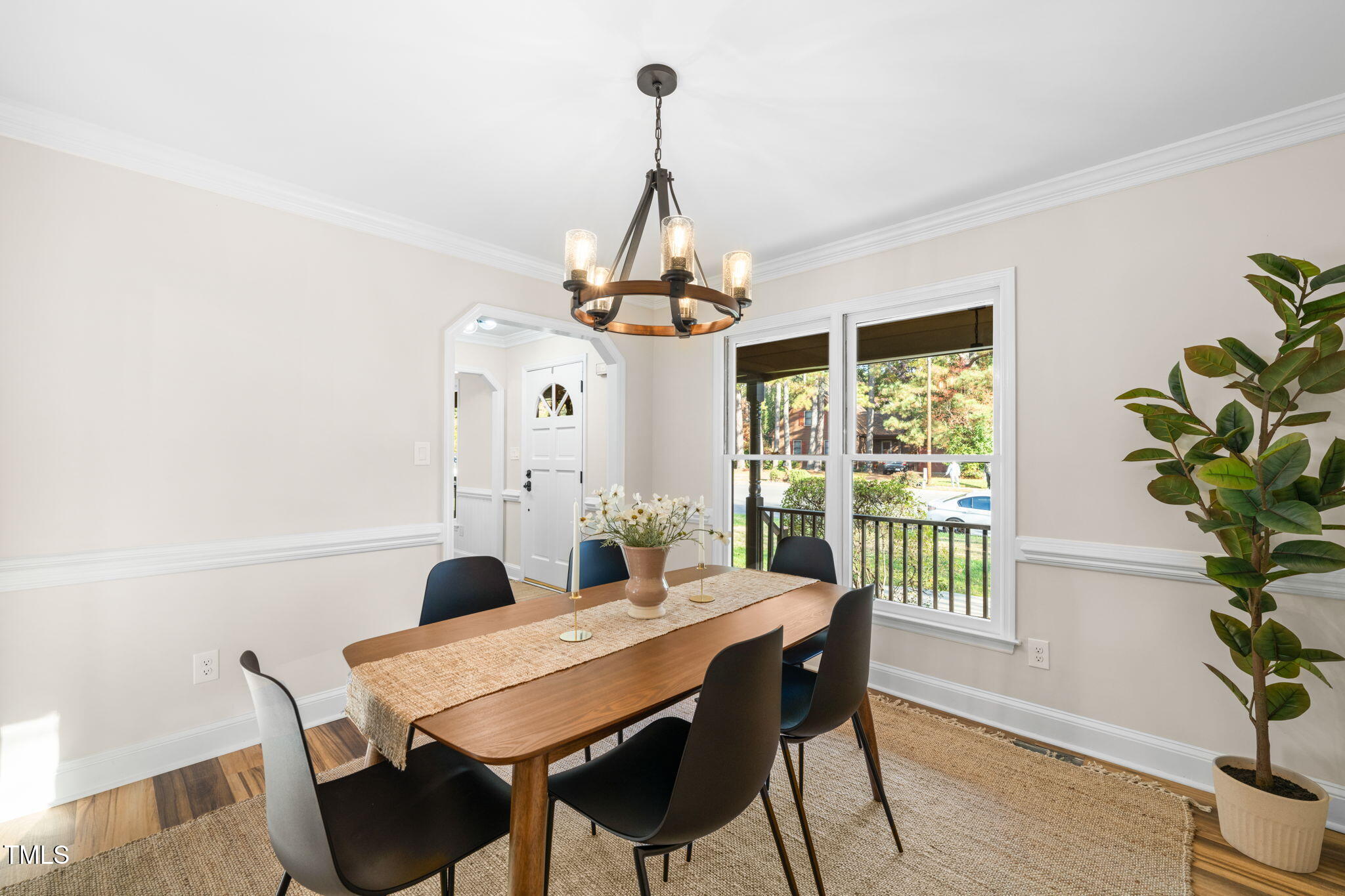 2512 Scouting Trail Raleigh, NC 27615 - Photo 8 of 36 a dining room with furniture a chandelier and wooden floor