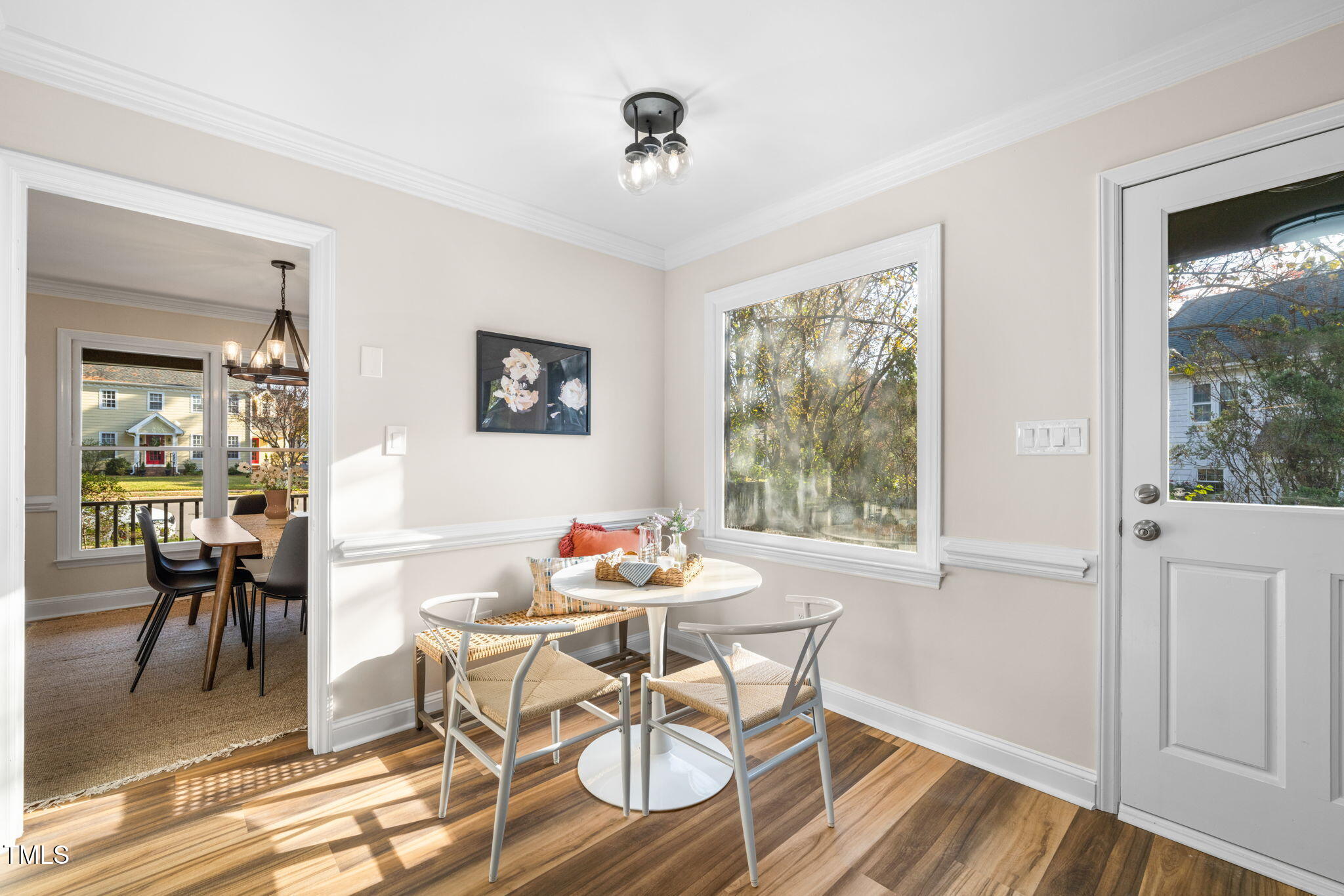 2512 Scouting Trail Raleigh, NC 27615 - Photo 10 of 36 a dining room with wooden floor a chandelier a glass table and chairs