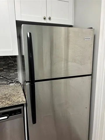 a view of a refrigerator in kitchen