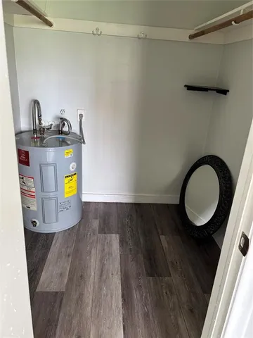 a view of a bathroom with a sink and wooden floor