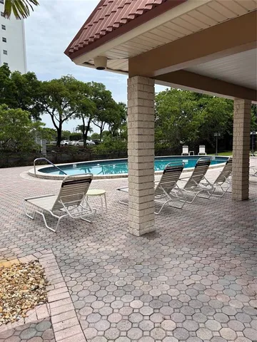 a view of a porch with chairs and backyard