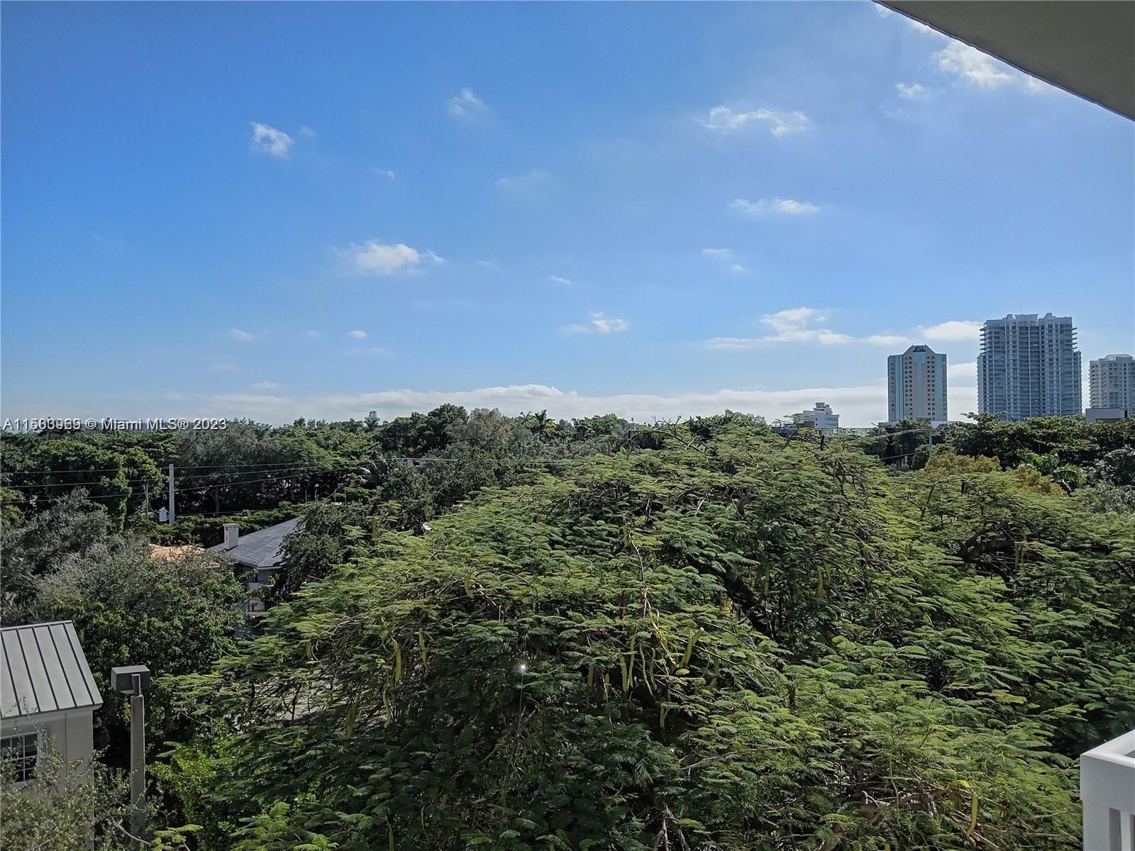 2740 Southwest 28th Terrace, Unit 507 Miami, FL 33133 - Photo 12 of 22 a view of a city with lush green forest