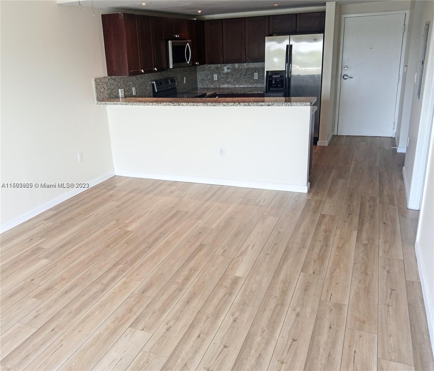 2740 Southwest 28th Terrace, Unit 507 Miami, FL 33133 - Photo 3 of 22 a view of a kitchen from the hallway
