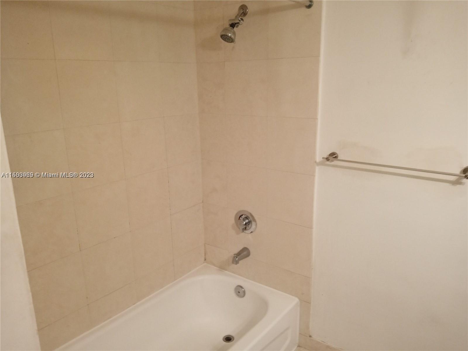 2740 Southwest 28th Terrace, Unit 507 Miami, FL 33133 - Photo 8 of 22 a bathroom with a white bath tub
