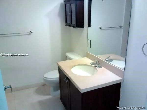 2740 Southwest 28th Terrace, Unit 507 Miami, FL 33133 - Photo 9 of 22 a bathroom with a sink toilet and a mirror