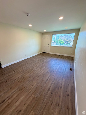 450 13800 South, Unit 2 Draper, UT 84020 - Photo 2 of 21 Spacious room featuring wood-finish flooring, recessed lighting, a white entry door, and a large front-facing window