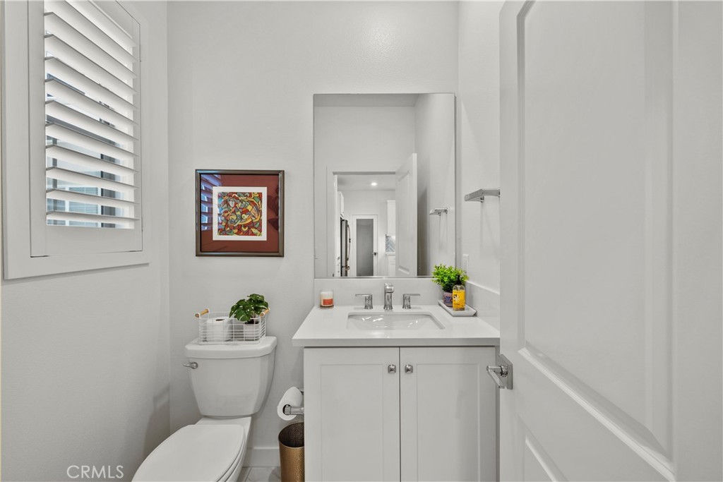 1663 Rosewell Road West Covina, CA 91791 - Photo 14 of 45 a bathroom with a toilet sink and mirror
