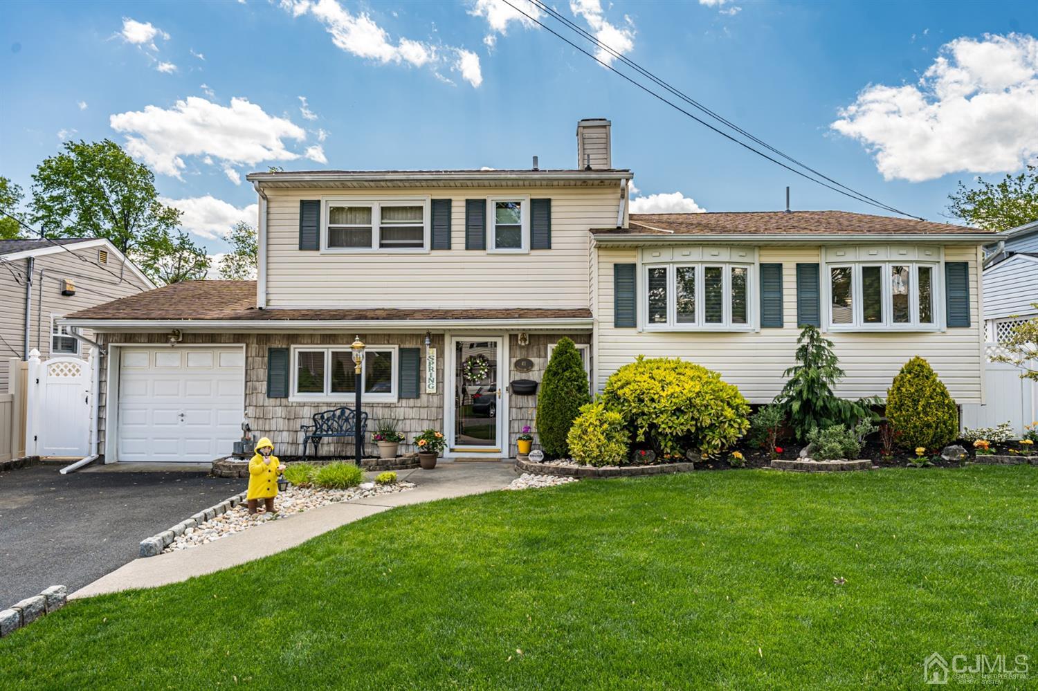 a front view of a house with garden and porch