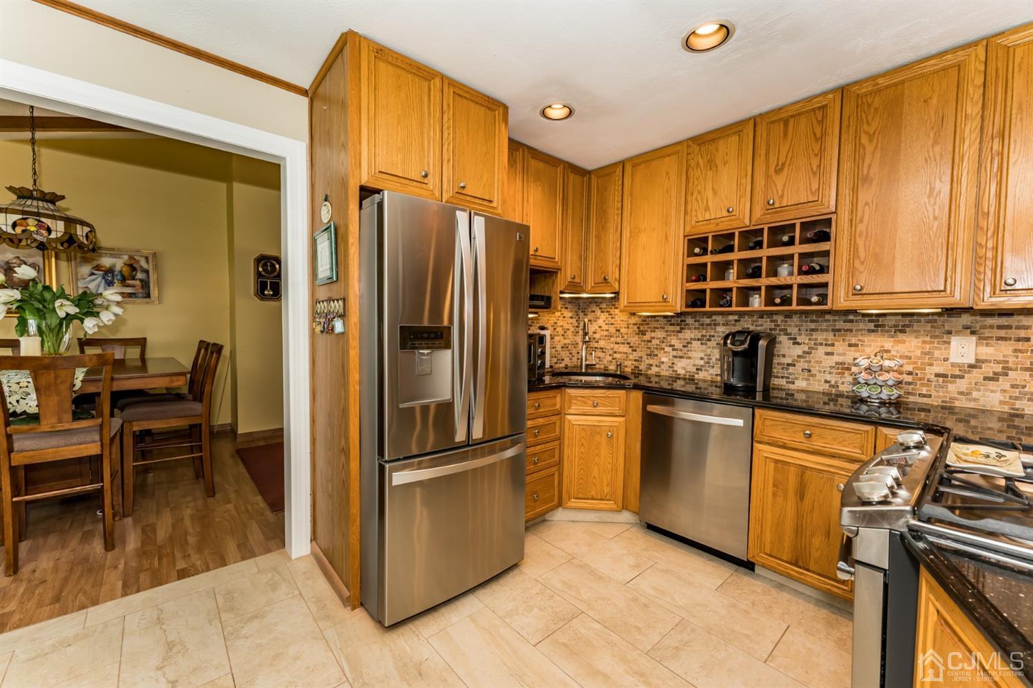 41 Trafalgar Drive Colonia, NJ 07067 - Photo 12 of 40 a kitchen with stainless steel appliances granite countertop a refrigerator and a stove top oven