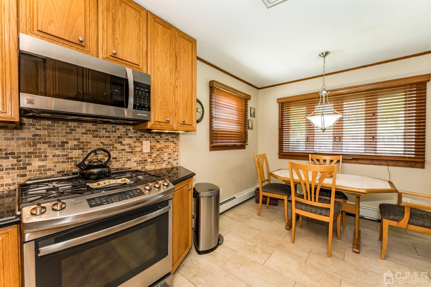 41 Trafalgar Drive Colonia, NJ 07067 - Photo 14 of 40 a kitchen with stainless steel appliances a stove a sink and a microwave