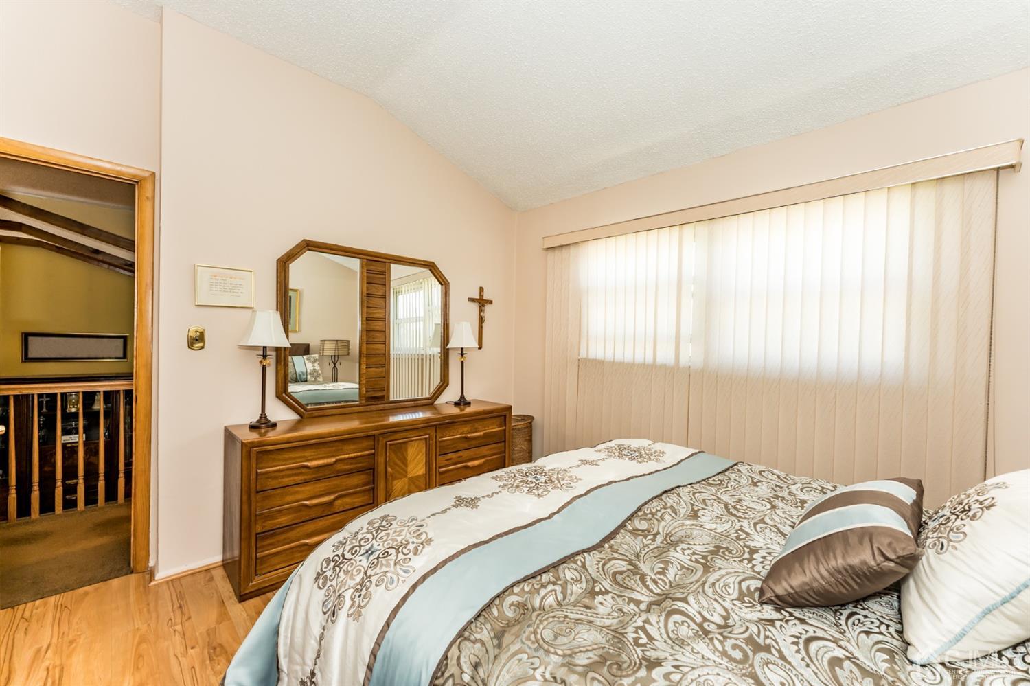 41 Trafalgar Drive Colonia, NJ 07067 - Photo 18 of 40 a bedroom with a bed and a dresser with mirror